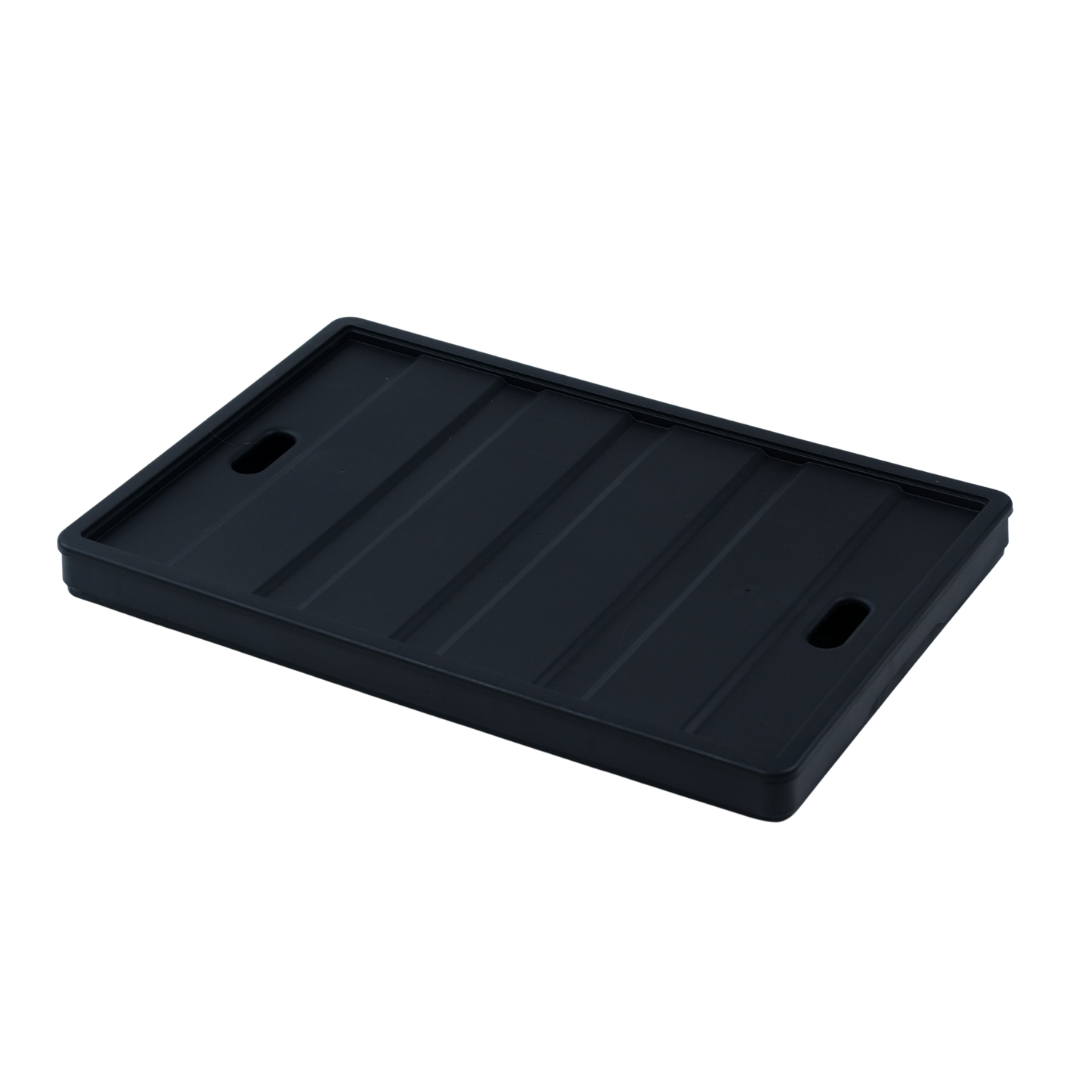 Black rectangular tray with ribbed surface on a white background