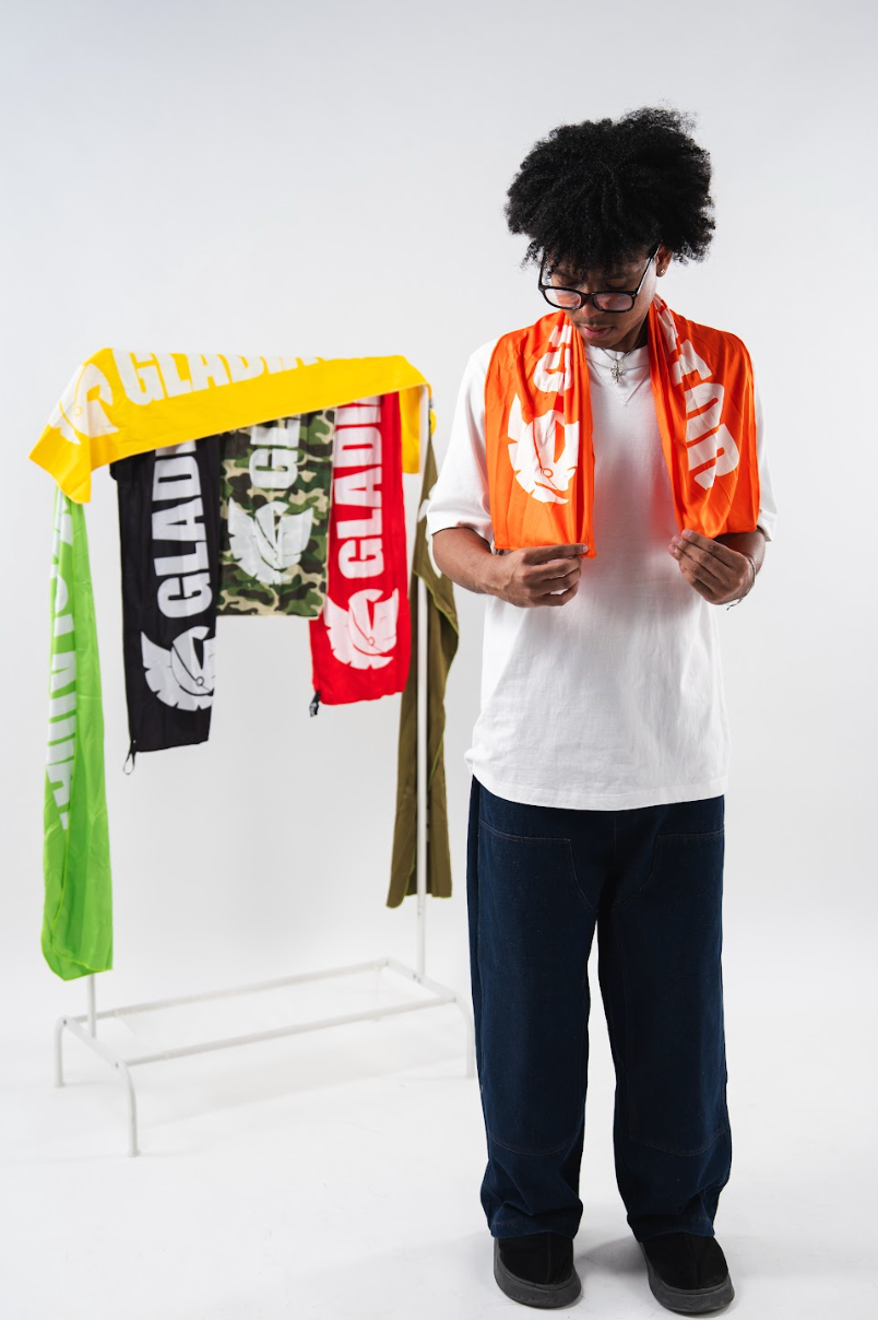 Person holding scarves with visible branding against a white background